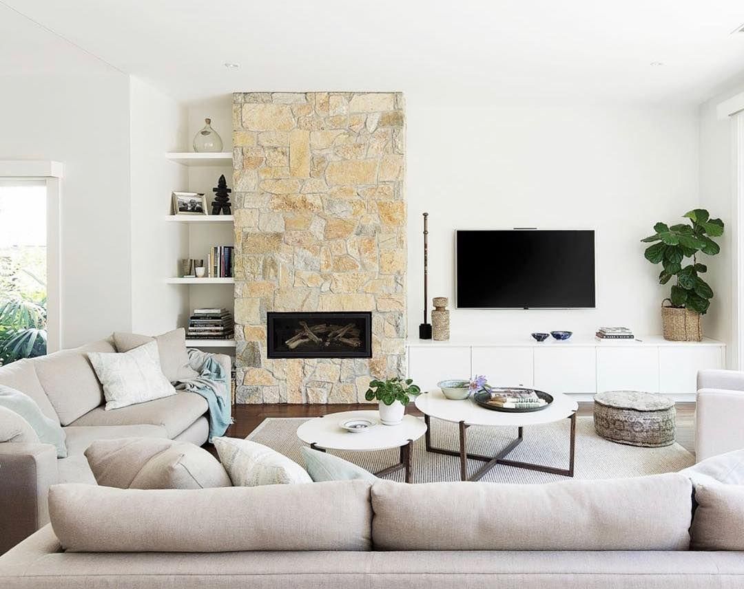 A living room with a fireplace, couch, coffee table and television — Kareela Constructions In Tamworth, NSW
