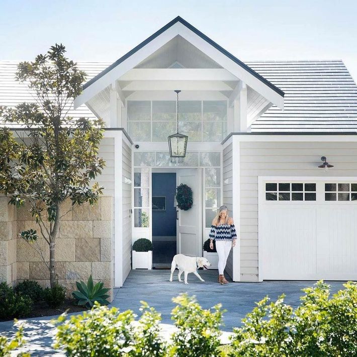 Woman and Dog in Front of New Built House
