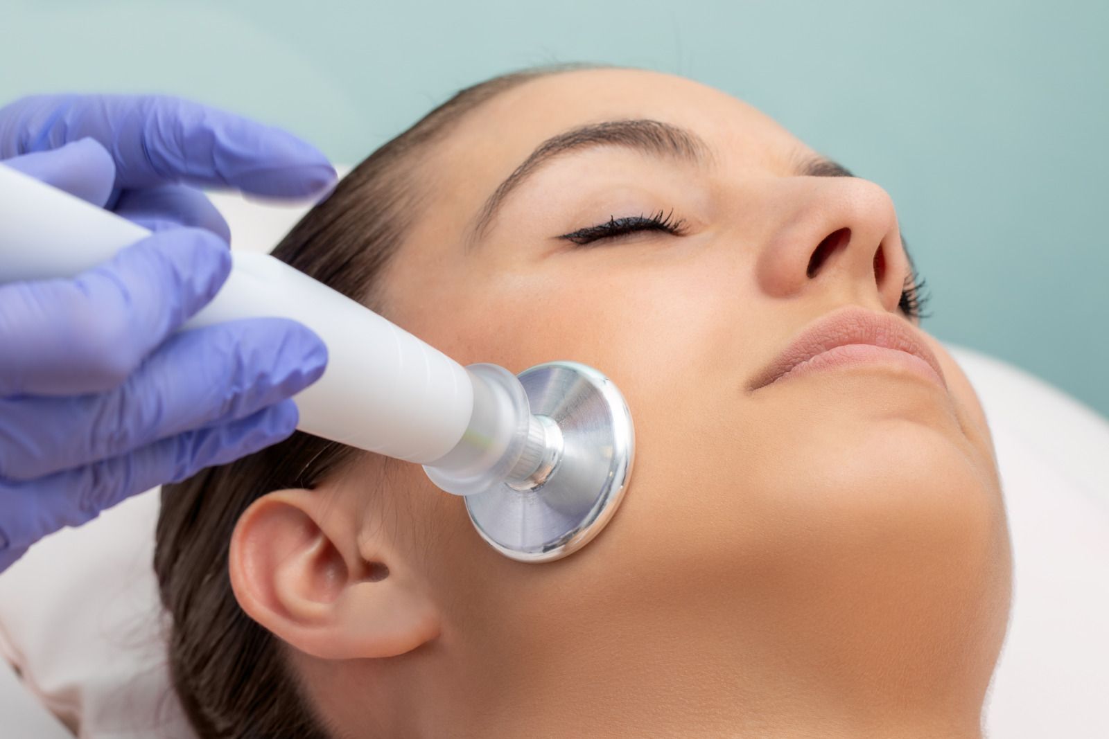 A woman is getting a facial treatment at a beauty salon.
