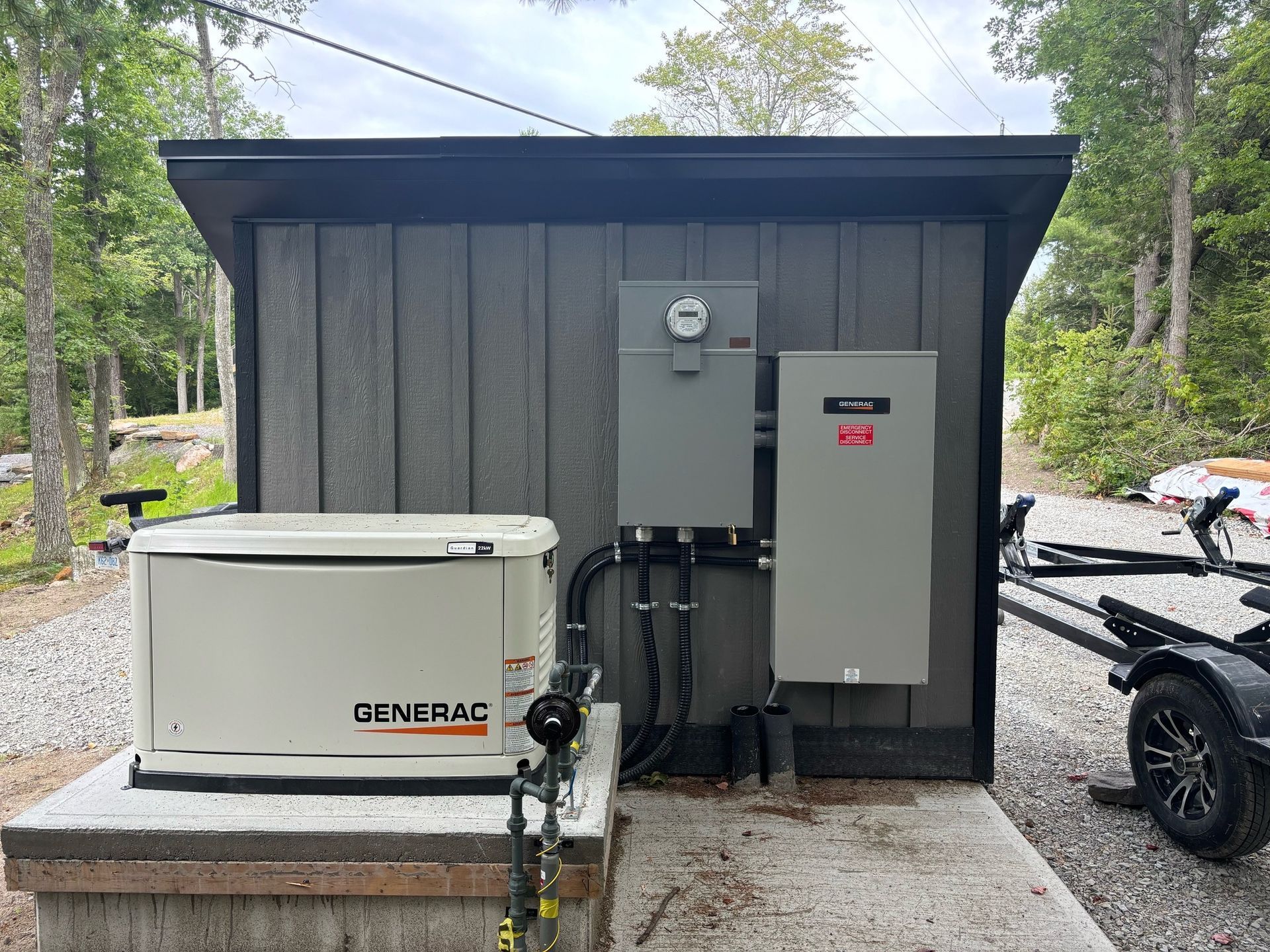 Residential Electrical Contractor - A generac generator is sitting on top of a pile of gravel