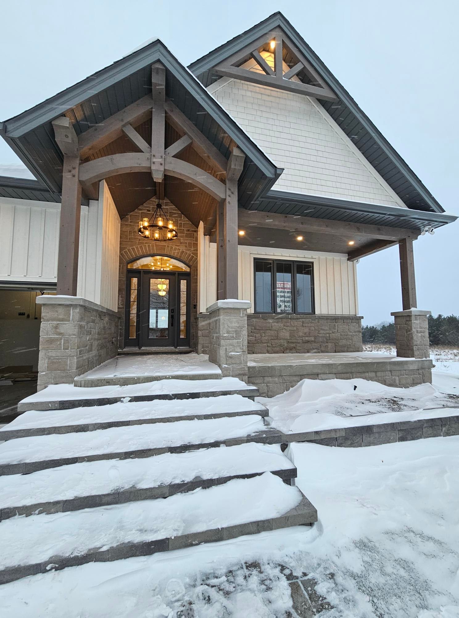 Residential Electrical Contractor - A large house with a porch and a garage