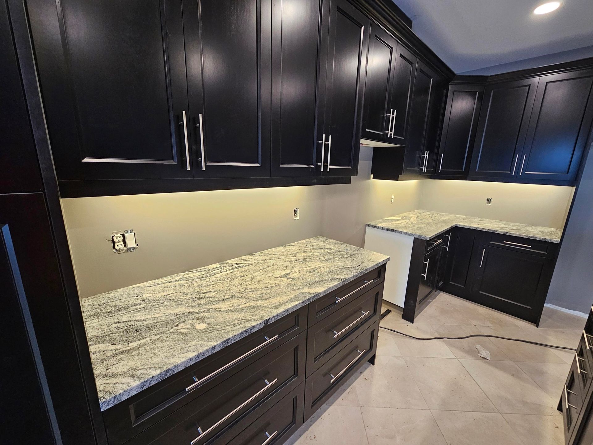 Residential Electrical Contractor - A kitchen with a sink and cabinets and a window