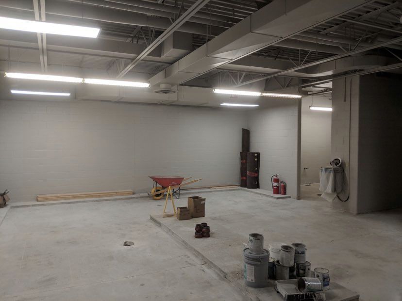 Commercial Electrical Contractor - There is a wheelbarrow in the middle of the room.