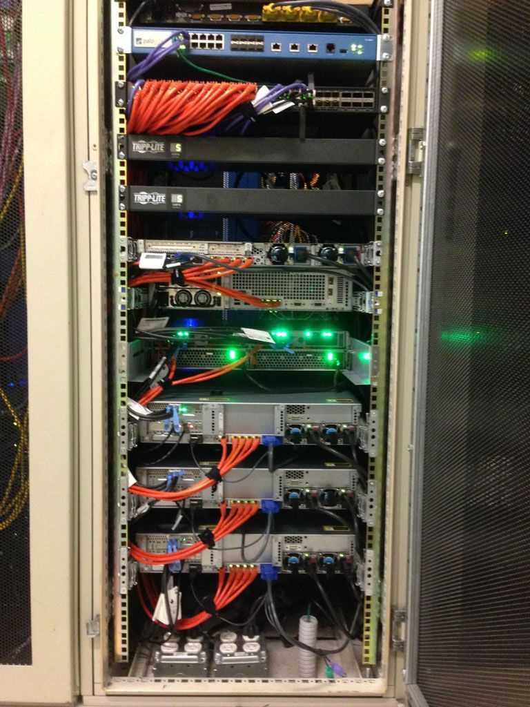 Commercial Electrical Contractor - A server rack with a lot of wires coming out of it
