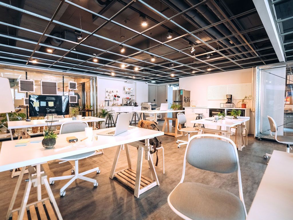 Commercial Electrical Contractor - A large open office with lots of desks and chairs.