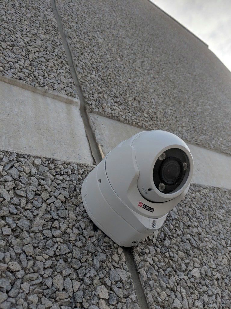 Industrial Electrical Contractor - A security camera is mounted on the side of a building.