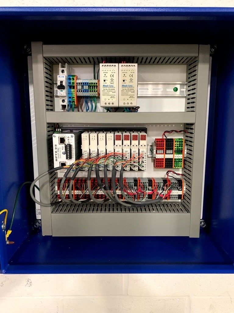 Industrial Electrical Contractor - The inside of a control panel with a lot of wires coming out of it.