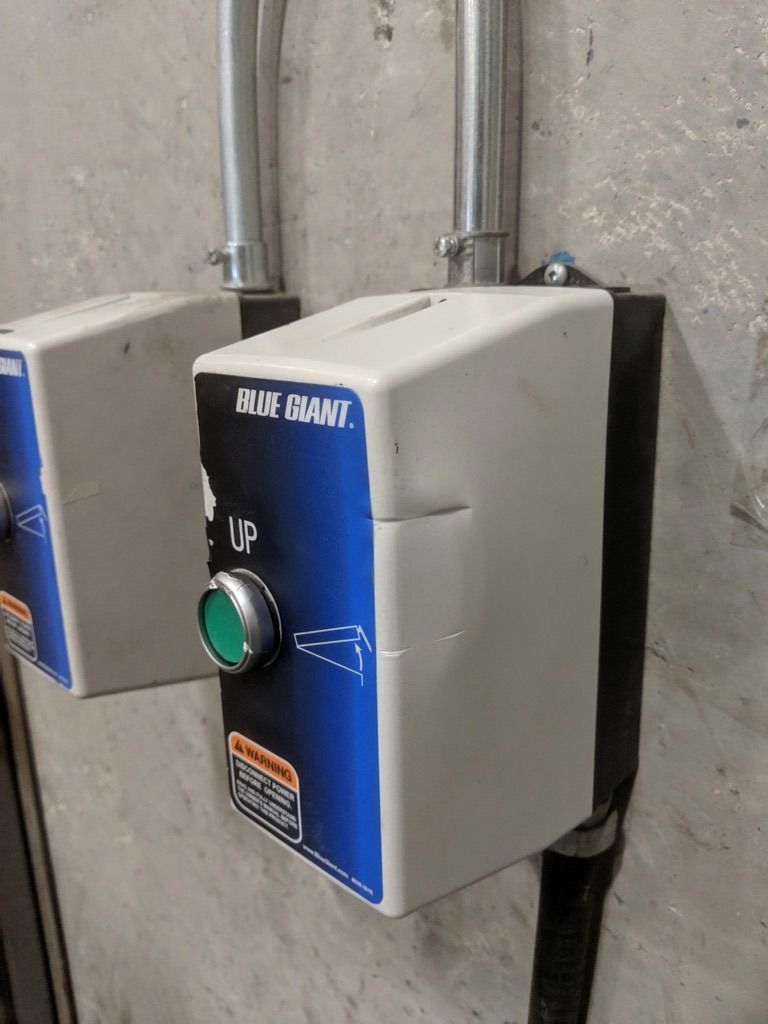 Industrial Electrical Contractor - A blue and white box with a green button on it