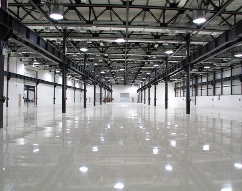 Industrial Electrical Contractor - An empty warehouse with lots of lights on the ceiling