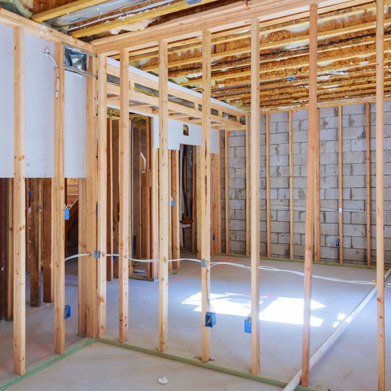 Residential Electrical Contractor - An empty room with wooden beams and brick walls