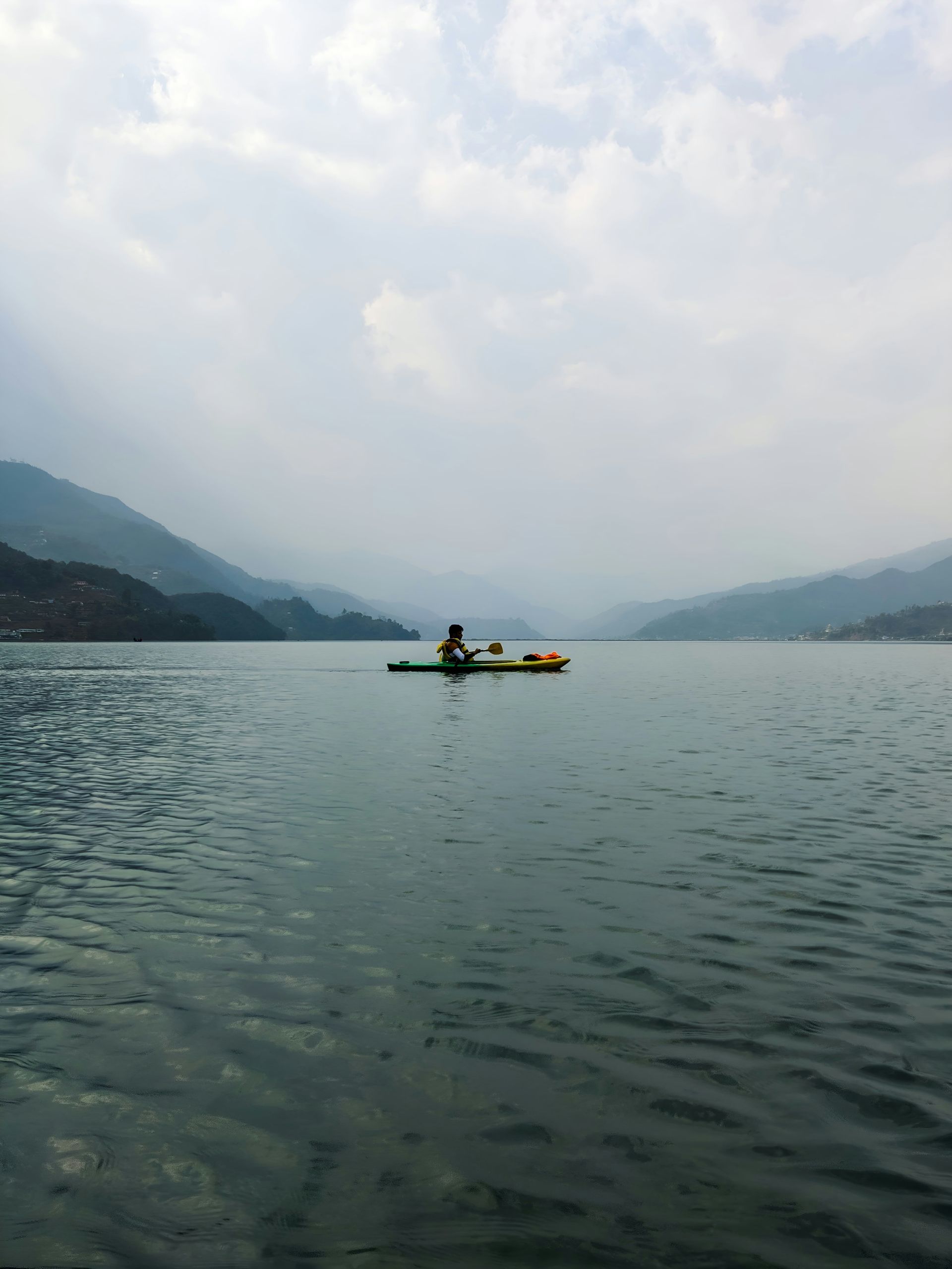 A person in a kayak on a lake.