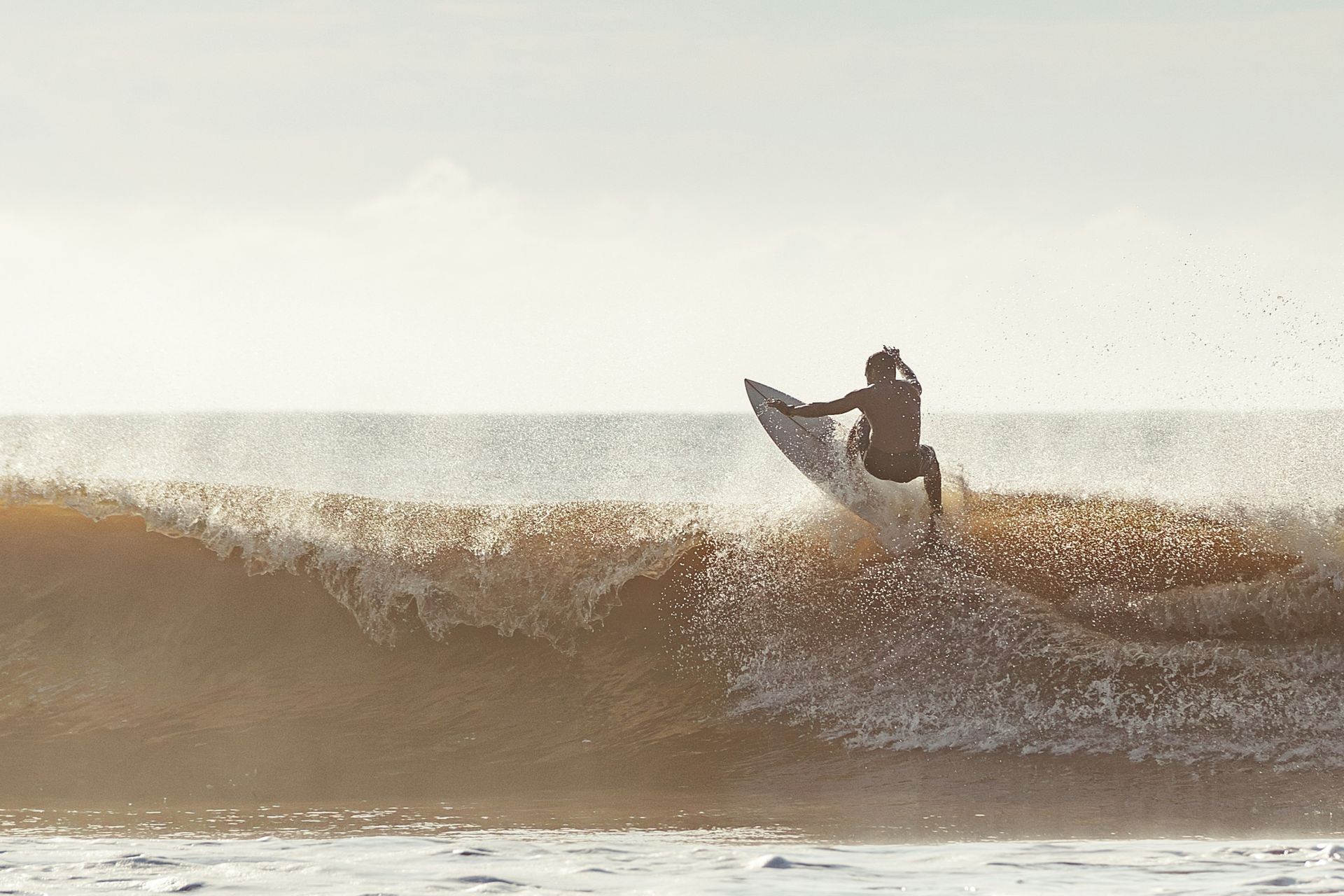 Surfer riding a wave in the ocean.