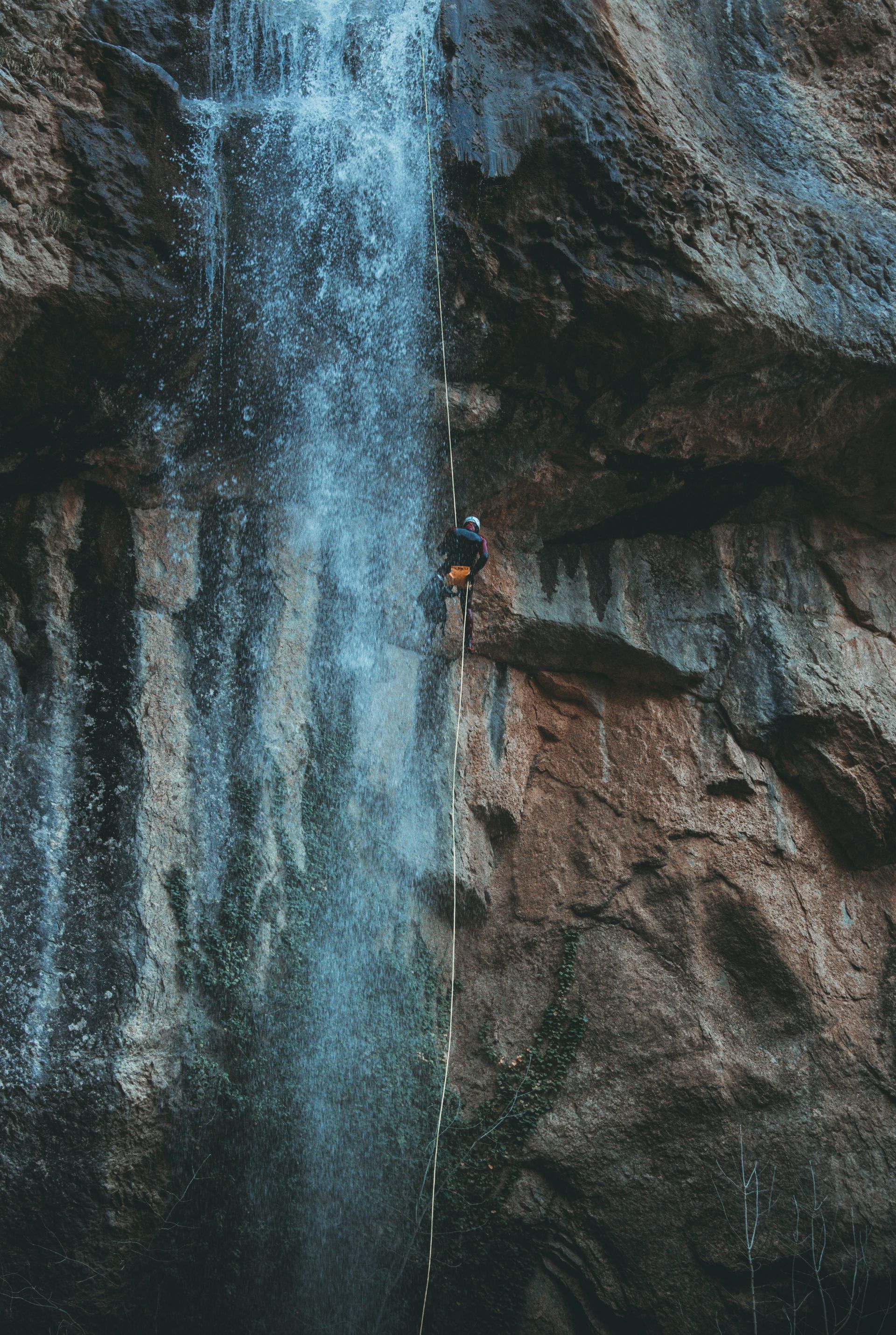 A man abseiling on a rock face.
