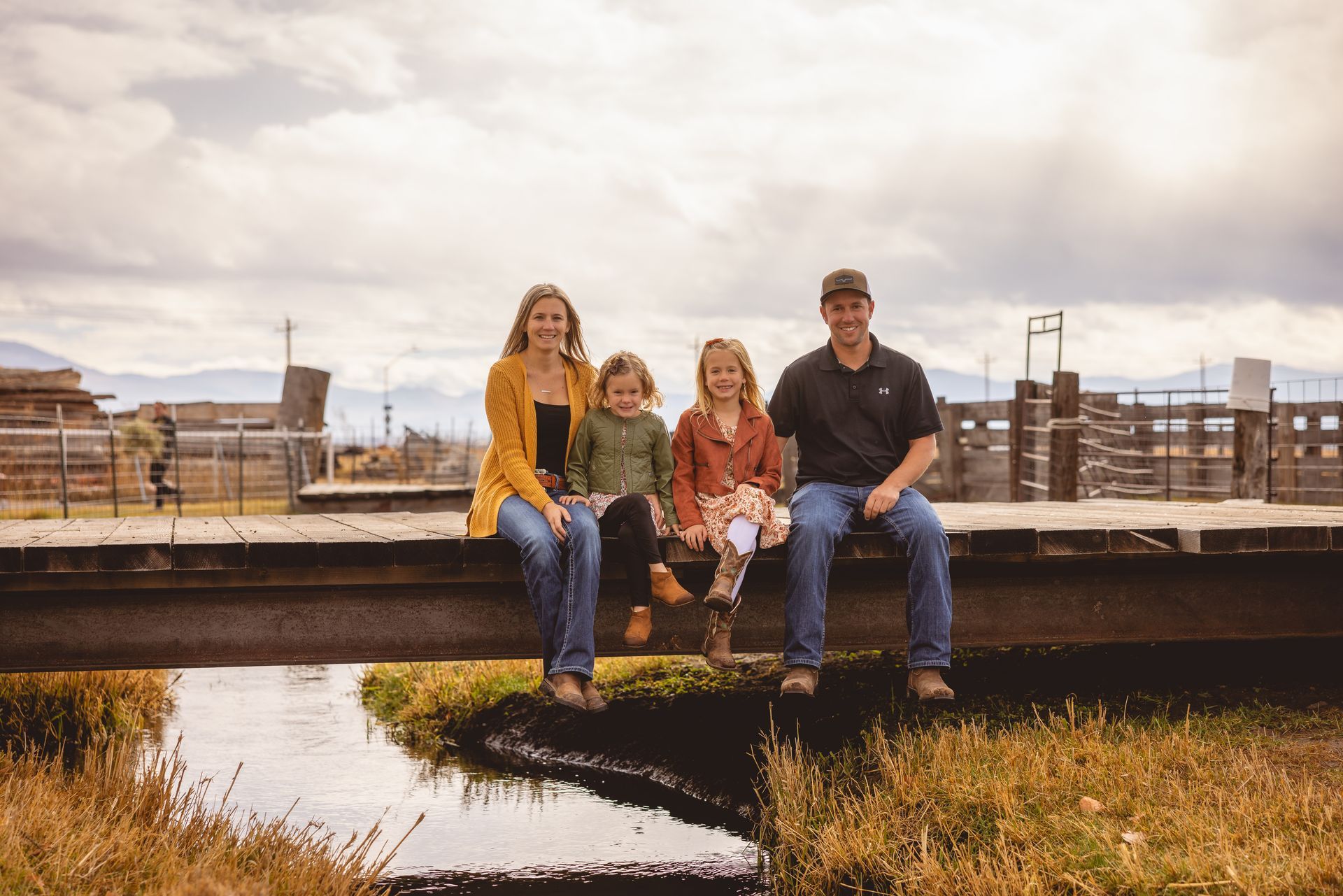 A kitchen with a large table and stools in it.