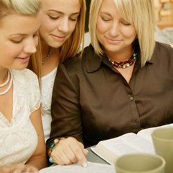 A tutor is teaching two teenage girls