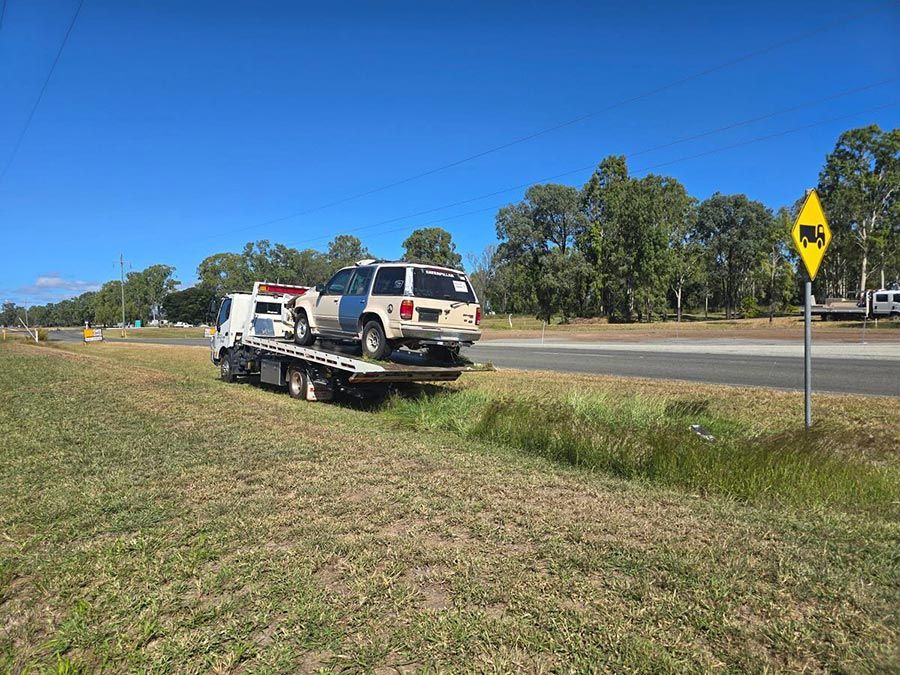 A Tow Truck is Towing a Car on the Side of the Road — Tow Biz in Park Avenue, QLD