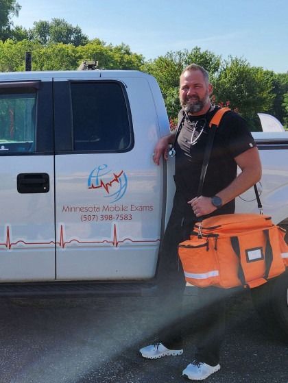 A man is standing in front of a truck that says minnesota medical supply
