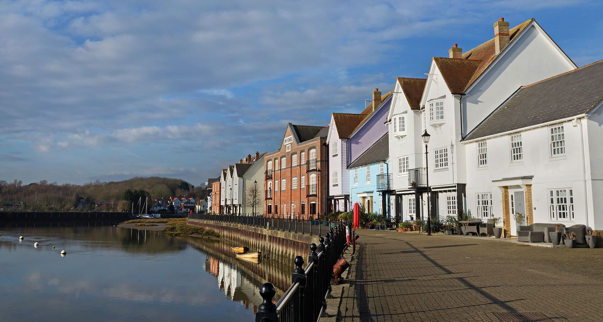A row of houses next to a body of water.
