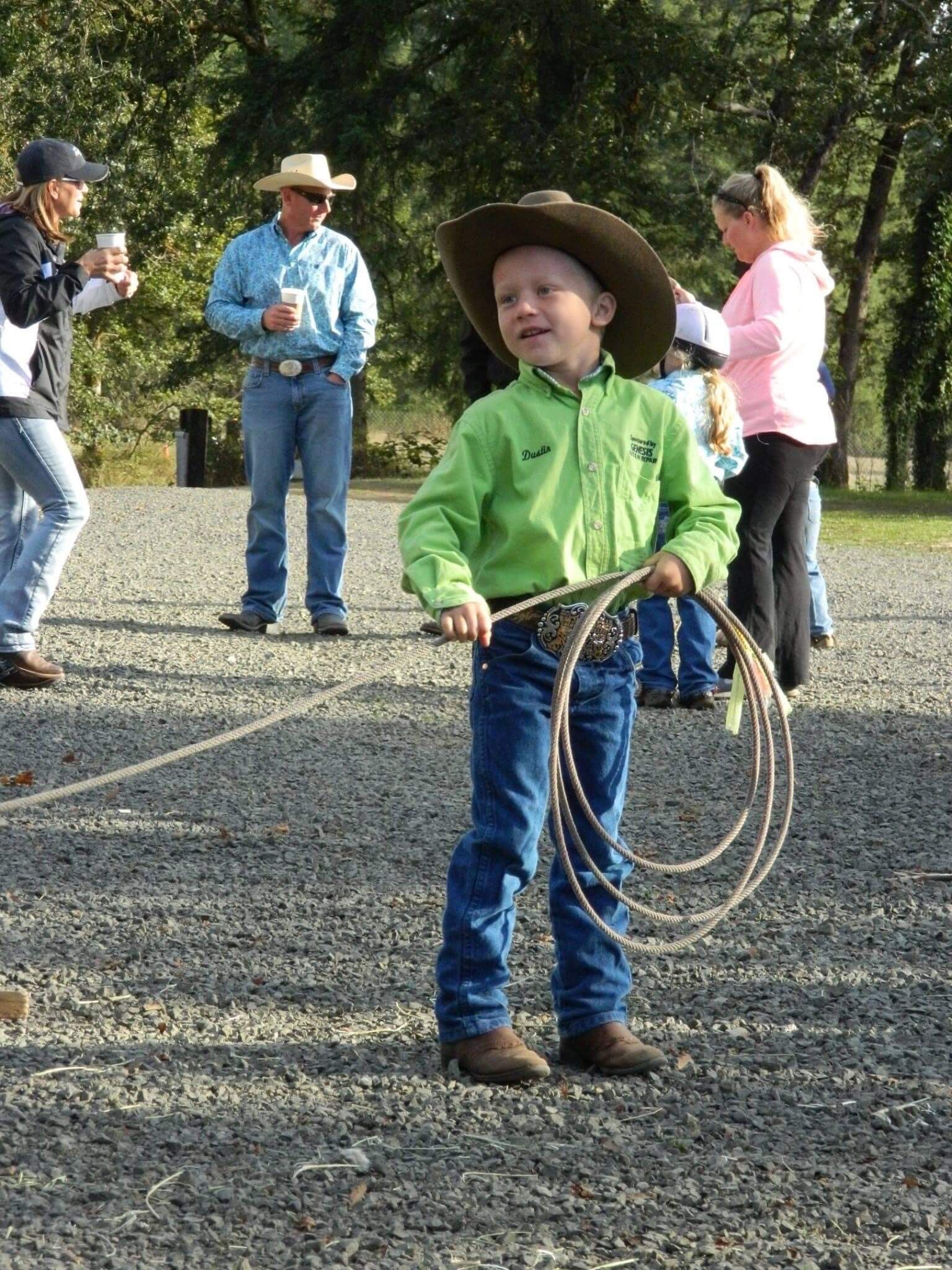 Young boy in cowboy hat and green shirt holding rope | Genesis Automotive and RV Repair