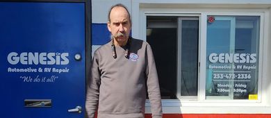 A man standing in front of his shop. The shop's name is "Genesis" | Genesis Automotive and RV Repair