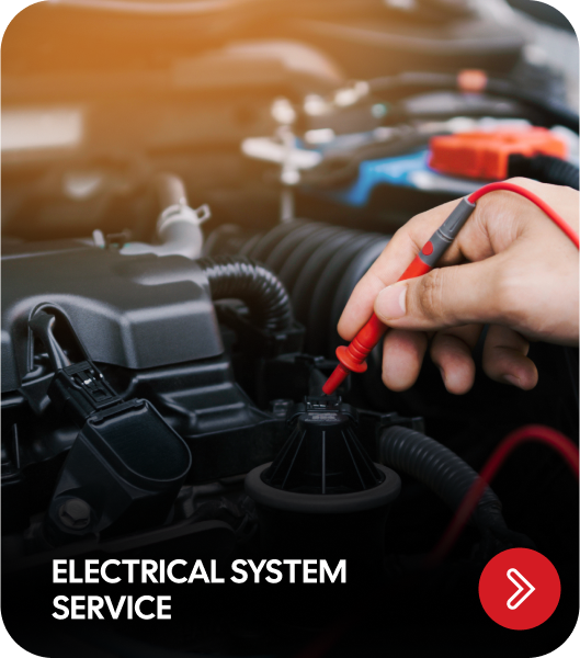 Mechanic testing car's electrical system with a red multimeter probe | Genesis Automotive and RV Repair