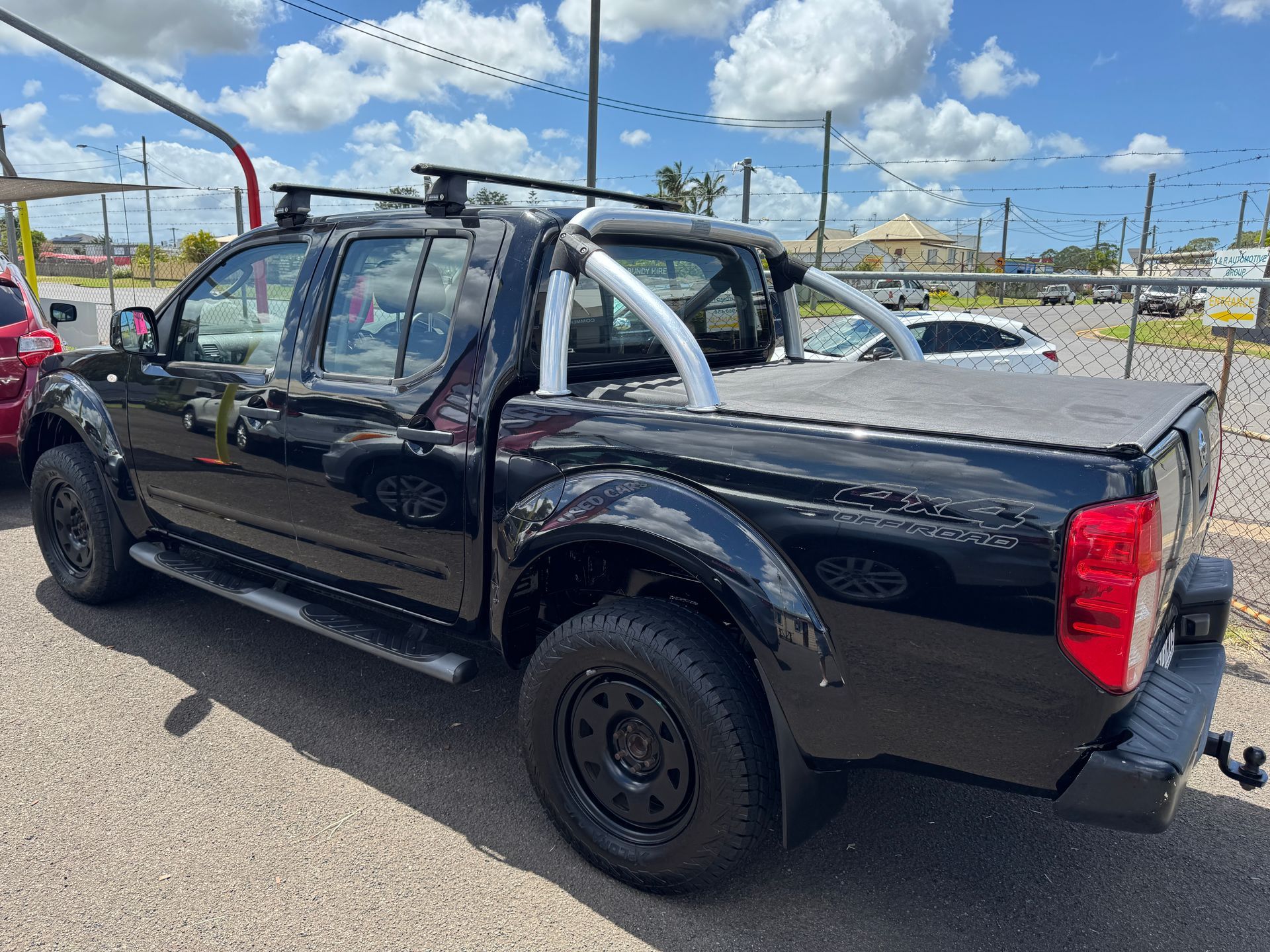 A Truck is Parked on the Side of the Road in Front of a Building — N & R Automotive Group in Bundaberg East, QLD