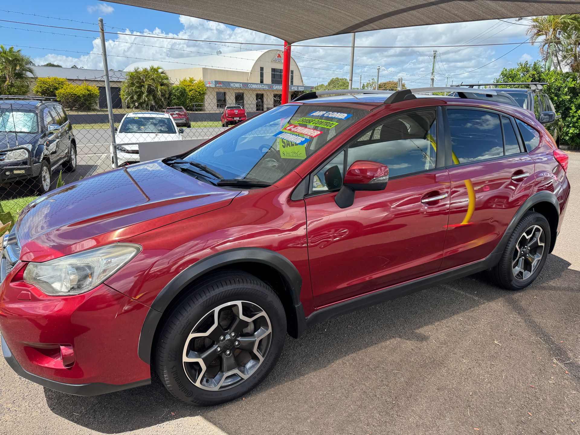 A Red Car Parked with a For Sale Sign — N & R Automotive Group in Bundaberg East, QLD