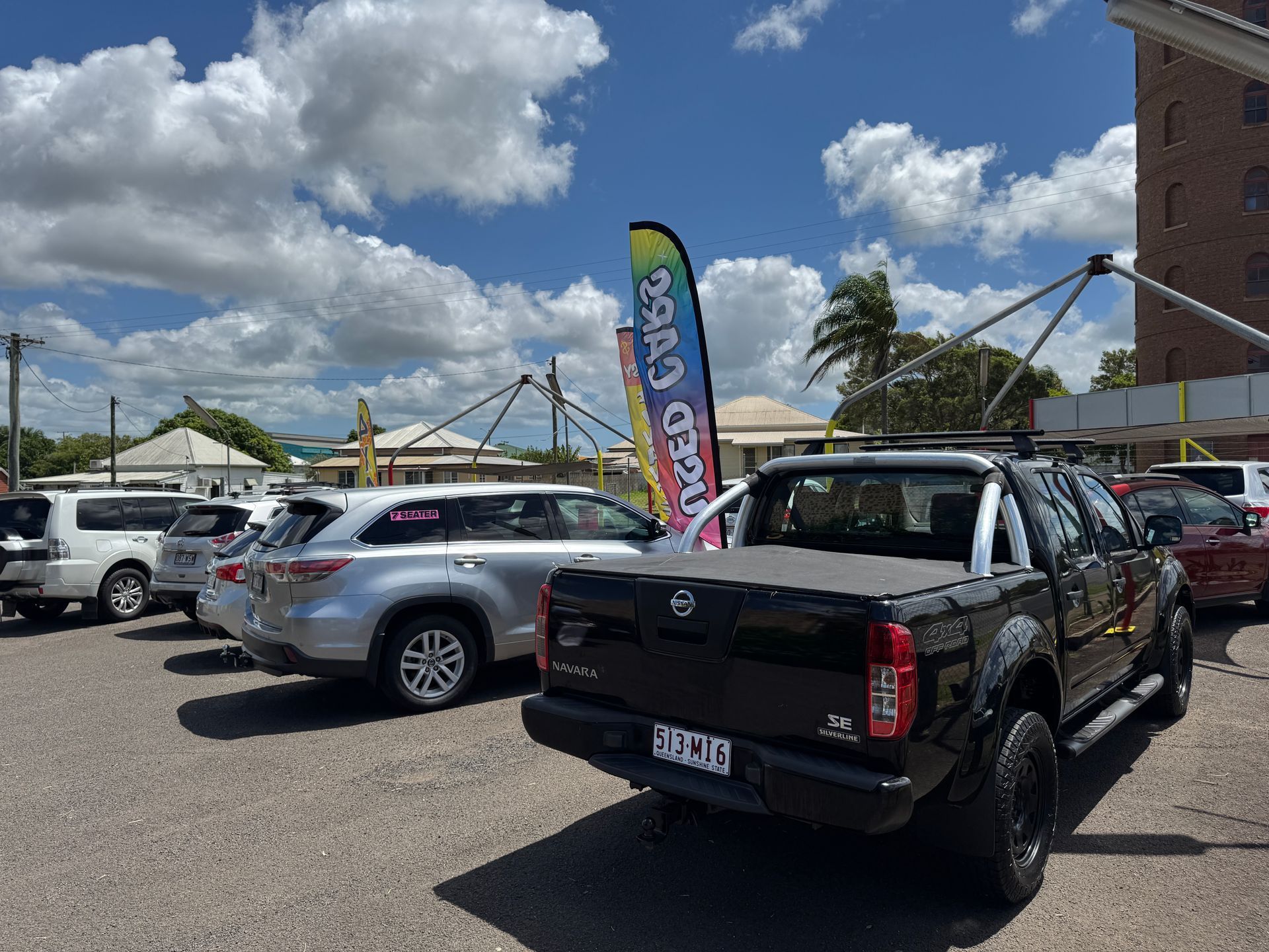 Multiple cars are Parked on the Side of the Road in Front of a Building — N & R Automotive Group in Bundaberg East, QLD