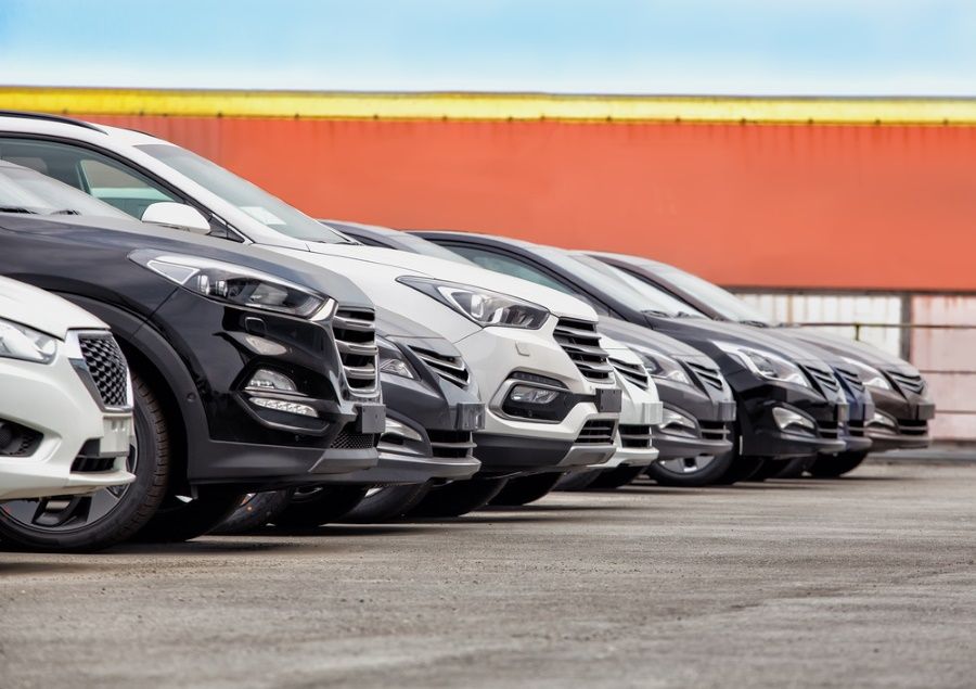 A Row of Cars Are Parked Under Shade Umbrellas — N & R Automotive Group in Bundaberg East, QLD