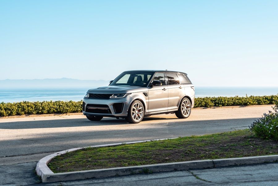 A Range Rover Sport is Parked on the Side of the Road Near the Ocean — N & R Automotive Group in Bundaberg East, QLD