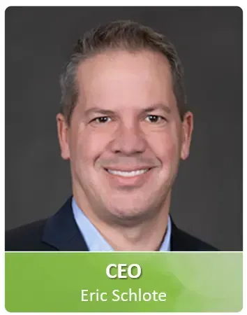 A man in a suit and tie is smiling for the camera.