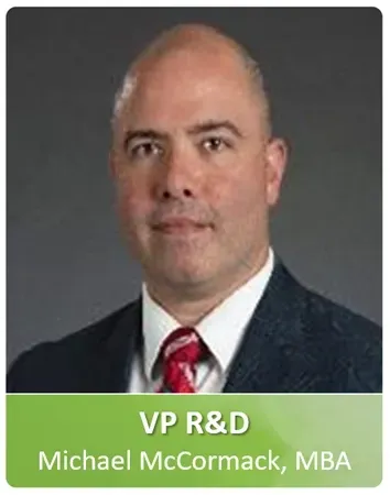 A man in a suit and tie is wearing a name tag.