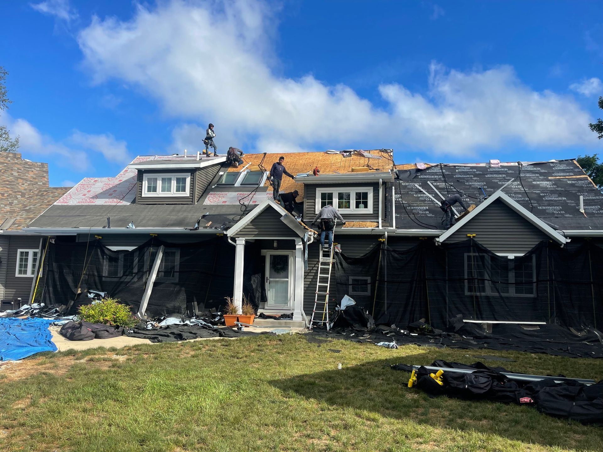 A large house with a roof that is being repaired.