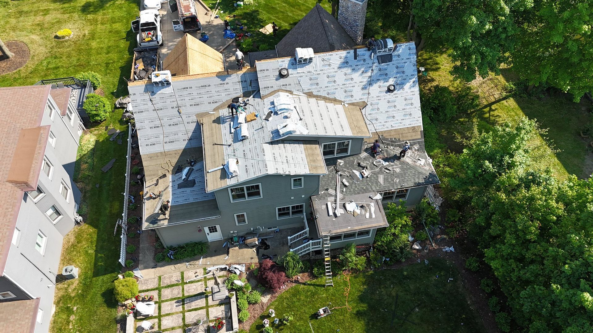 An aerial view of a house being remodeled with a new roof.