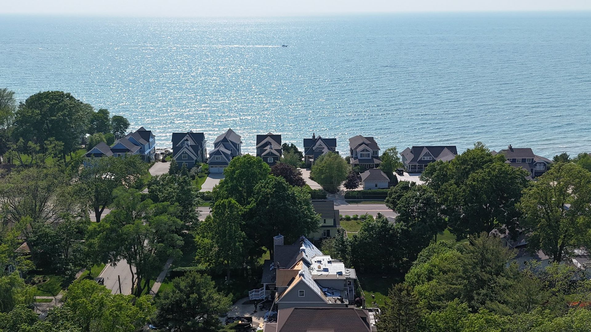 An aerial view of a residential area next to the ocean.