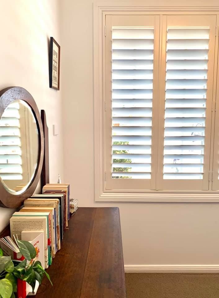 Wooden Dresser With Books and a Mirror Next to a Window — Glenn Koek - Shutters - Curtains - Blinds in West Wollongong, NSW
