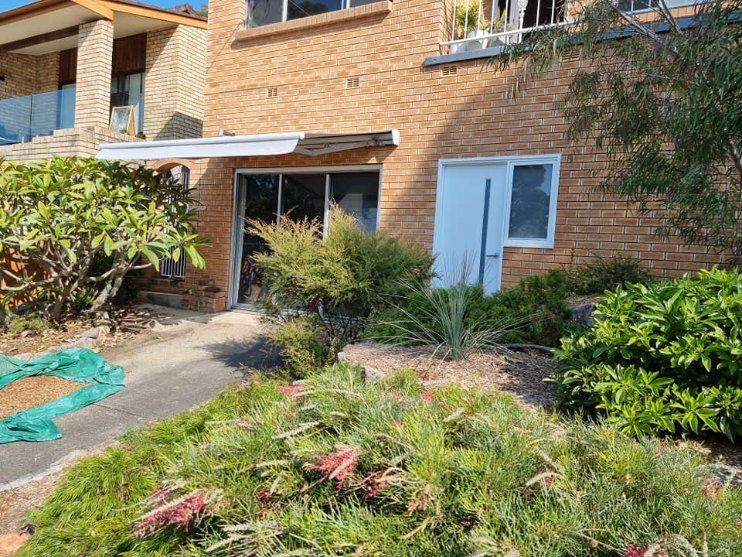 A Brick Building With a Garden, a Covered Entrance — Glenn Koek - Shutters - Curtains - Blinds in Sutherland Shire, NSW