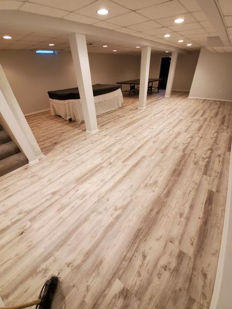 A large room with a wooden floor and white walls.