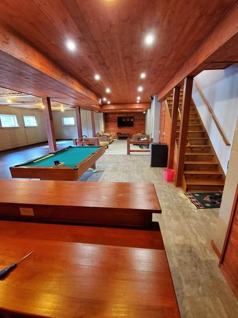 There is a pool table in the middle of the room.