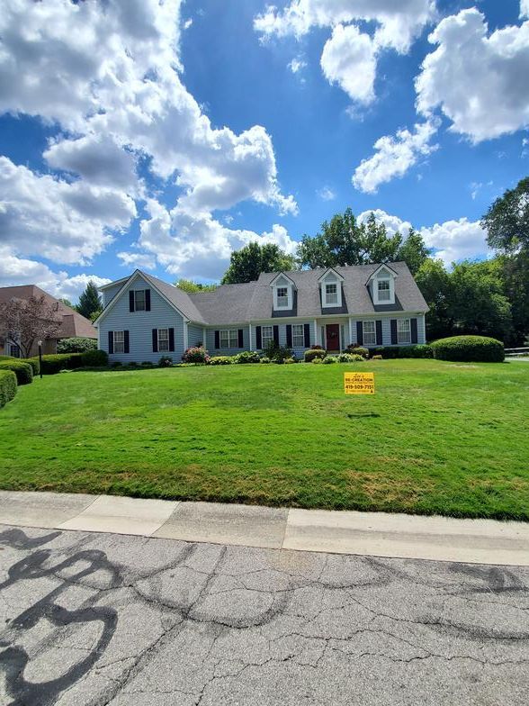 A large house with a large lawn in front of it