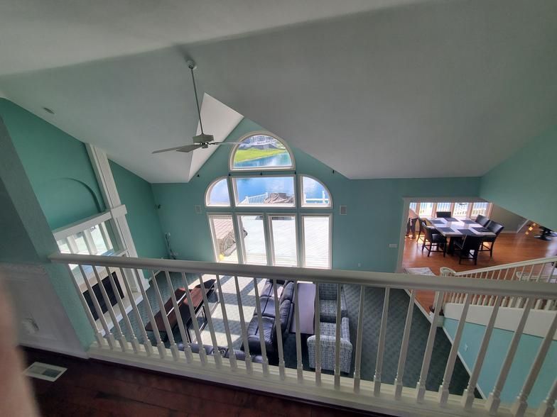 A view of a living room from the second floor of a house.