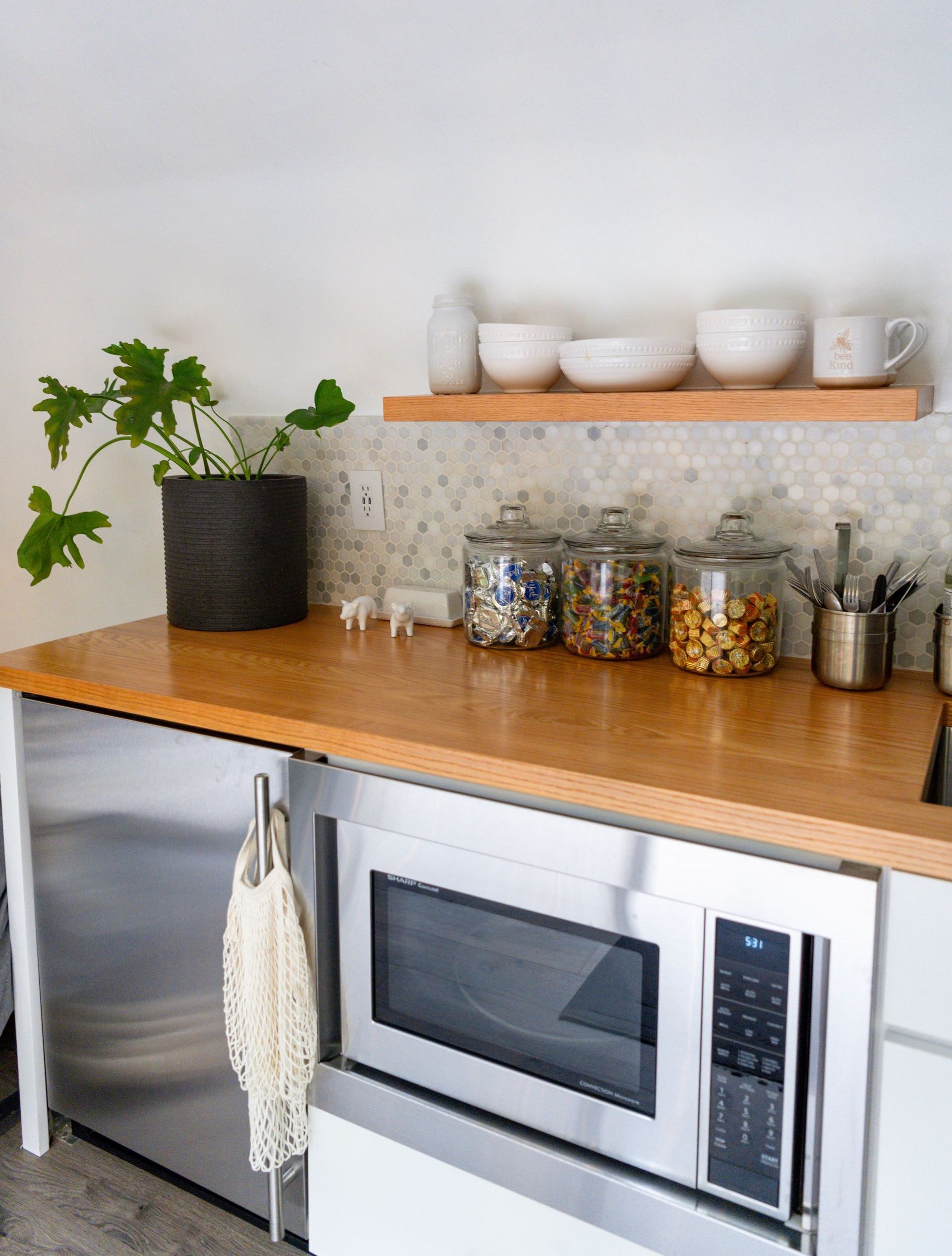 Kitchen counter with a sleek, modern design featuring a mounted microwave.