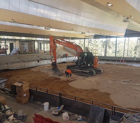 Man Cleaning A Mini Truck — C & E Earthmoving in Moss Vale, NSW