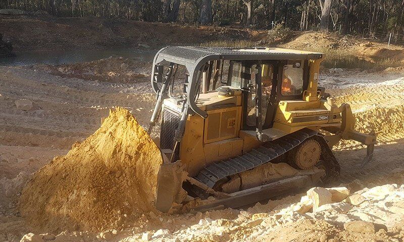 Mini Yellow Bobcat Truck — C & E Earthmoving in Moss Vale, NSW