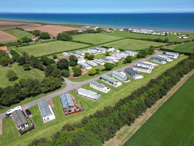 An aerial view of a holiday park in yorkshire with lodges