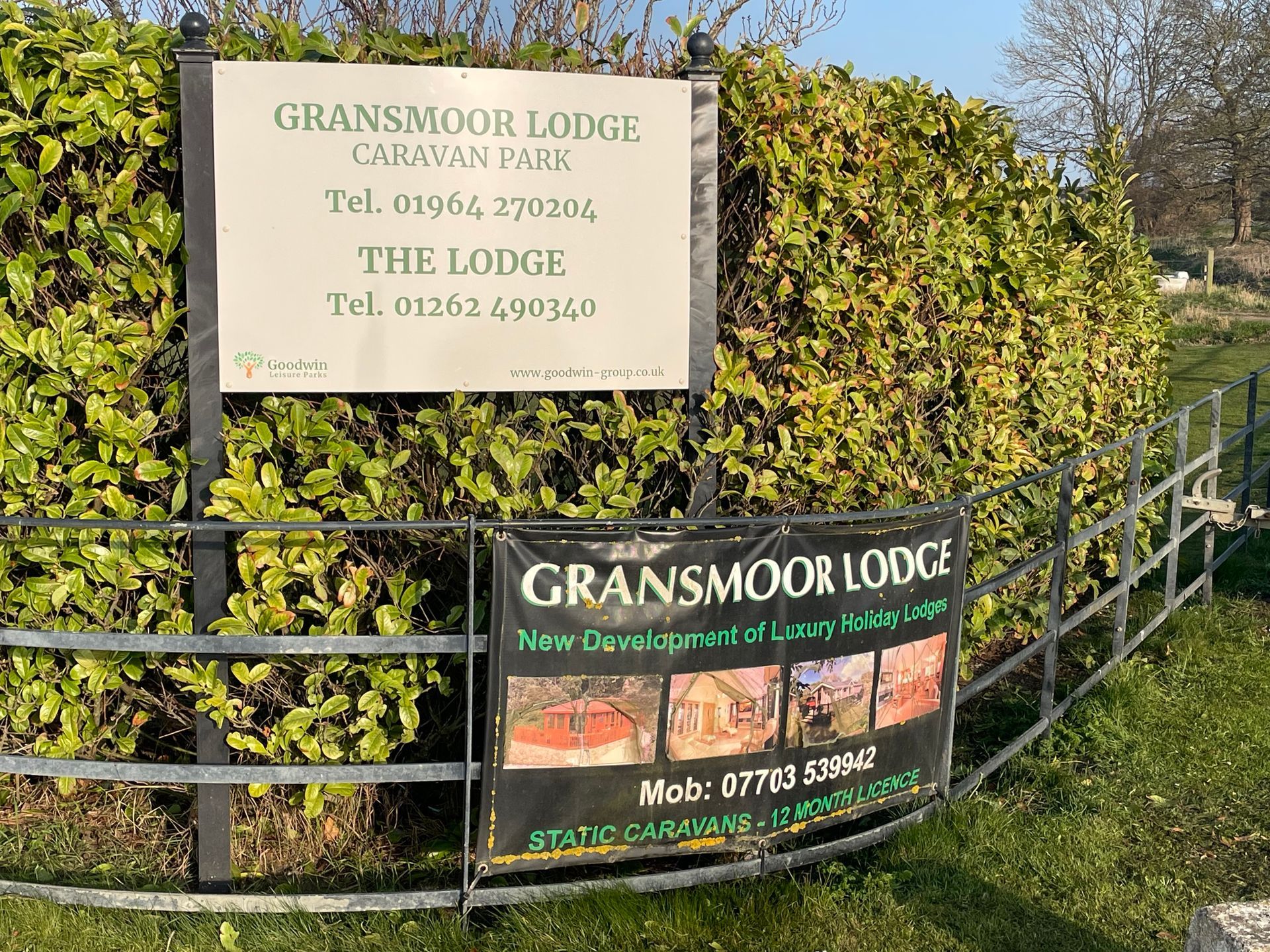 Sign for Gransmoor Lodge Caravan Park with phone numbers. A banner advertises static caravans.