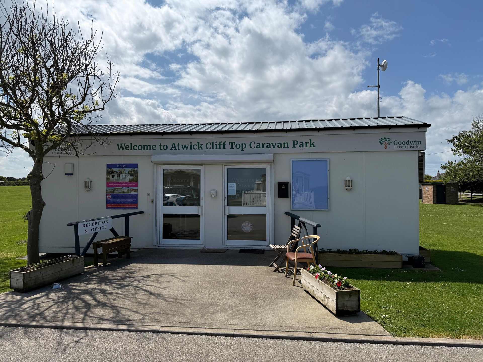 White building: reception for a caravan park. Text: