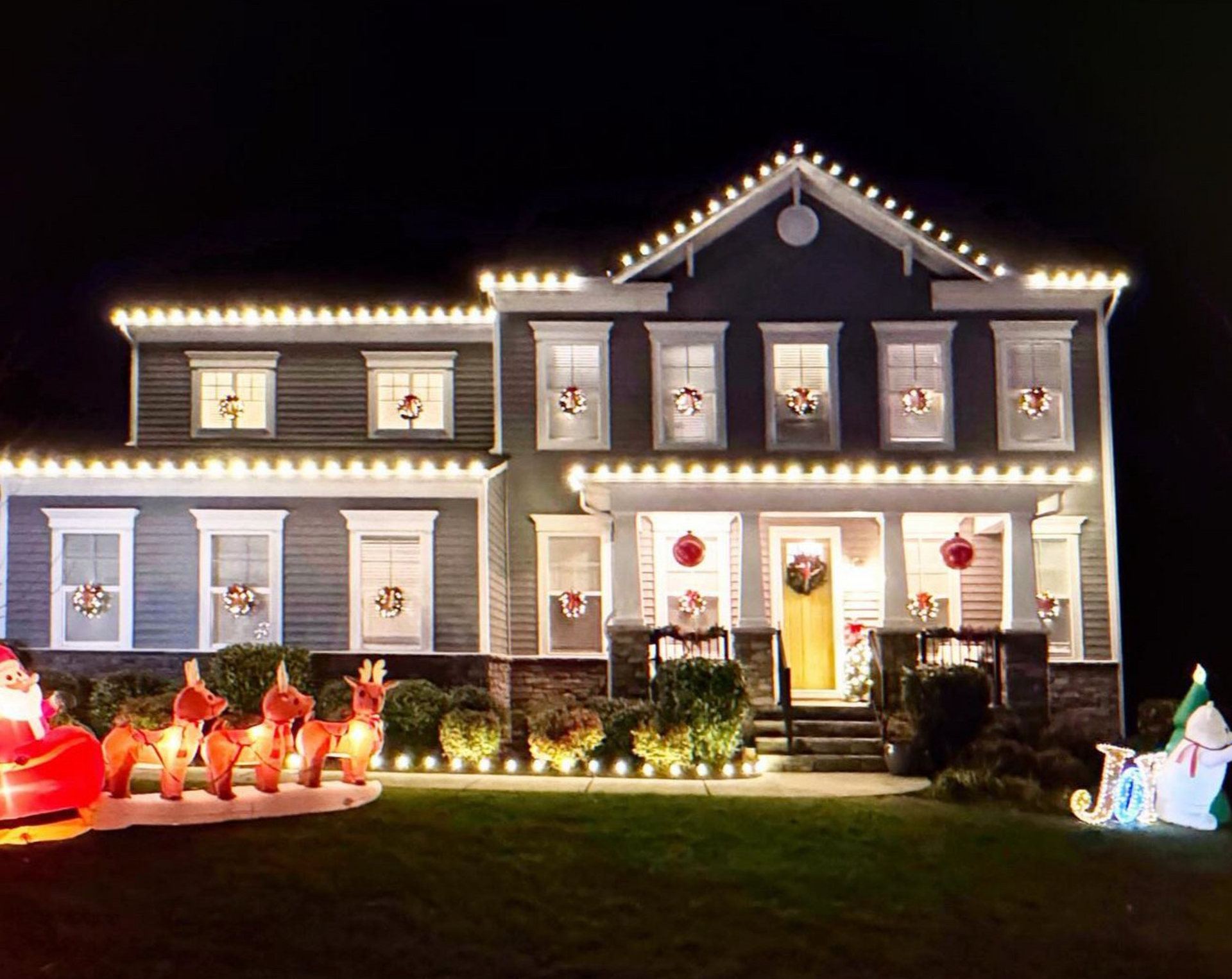 A man is cleaning a sidewalk with a high pressure washer