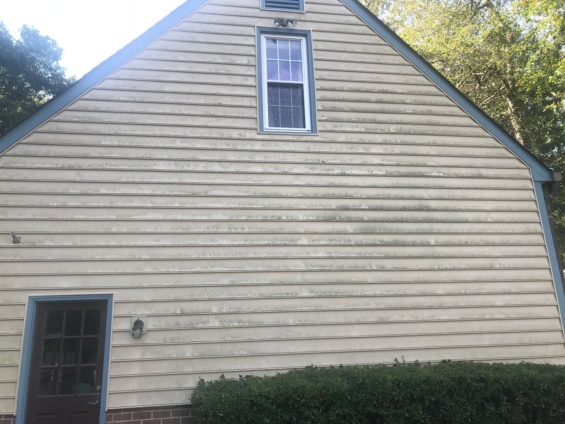 The side of a house with a window and a door