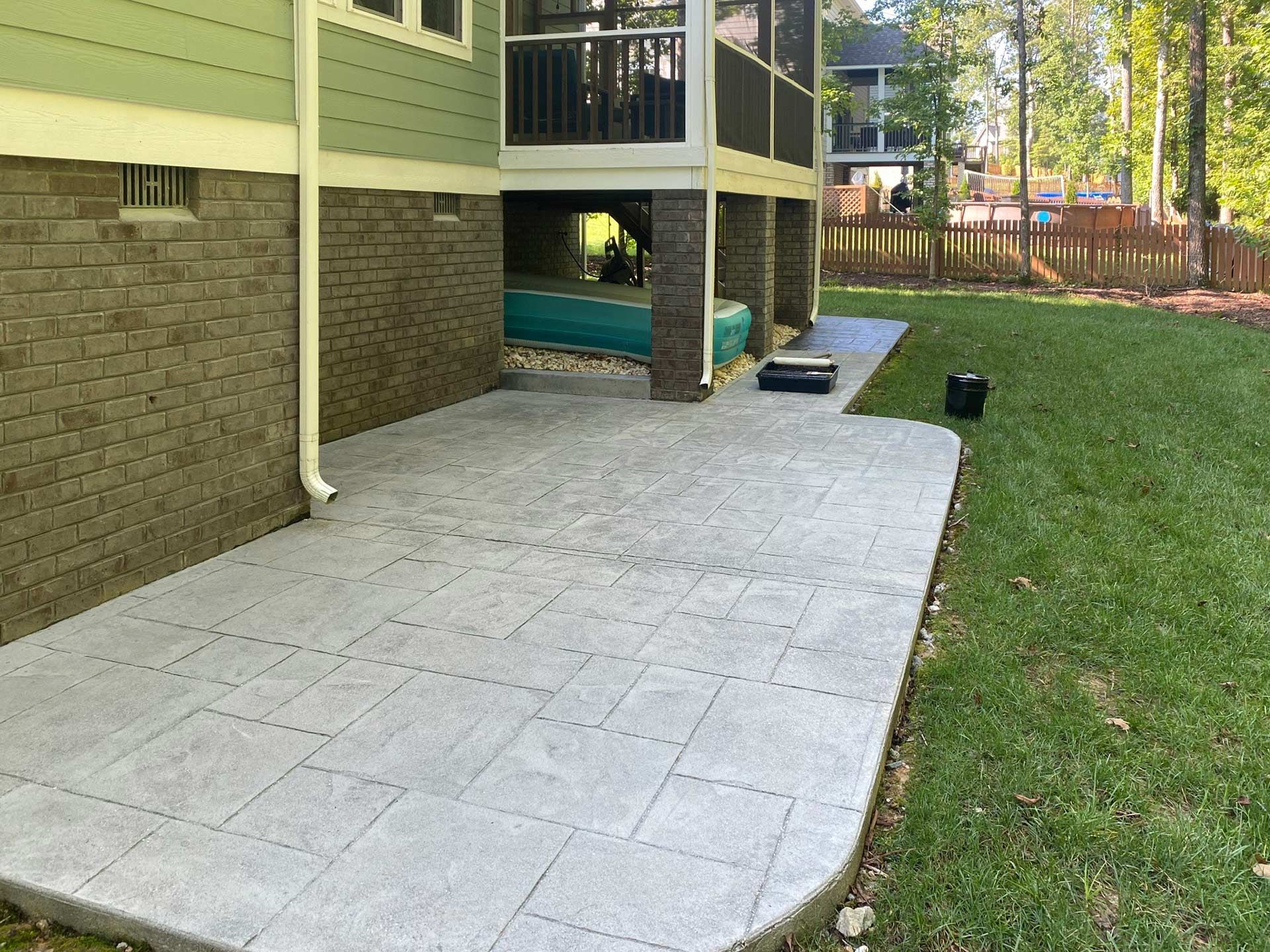 A patio is being built in the backyard of a house